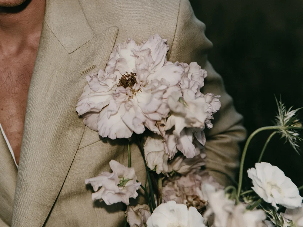 Male guest wearing a floral pin.