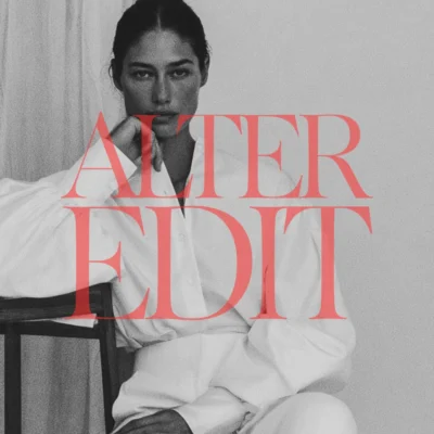 Black-and-white seated portrait of a woman in a white suit, overlaid with red Alter Edit lettering.